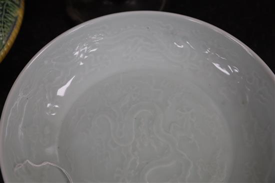 A Chinese pale celadon glazed dragon dish, D. 24.7cm